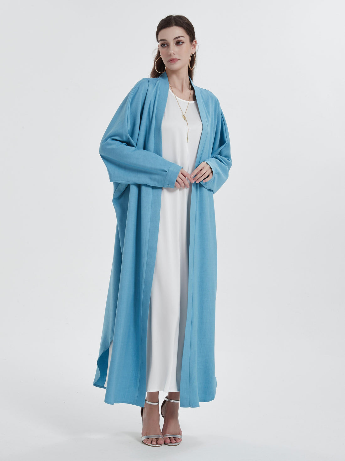 Open abaya styled casually with sneakers