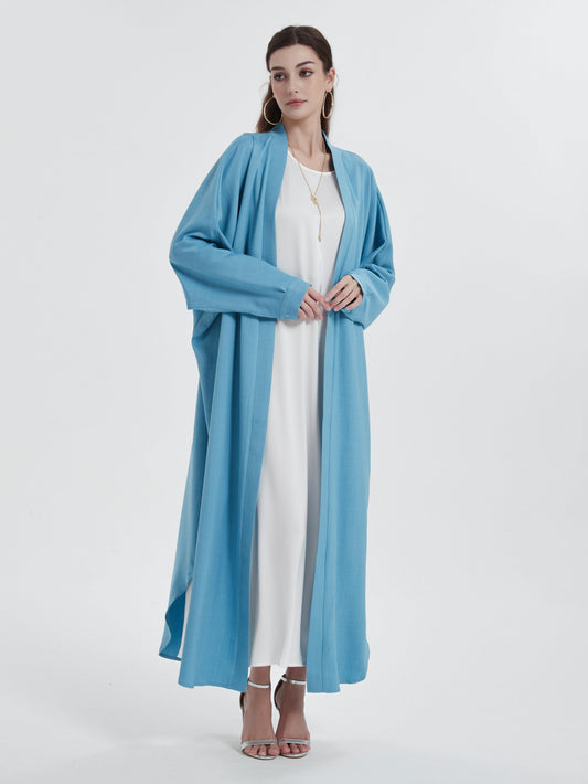 Open abaya styled casually with sneakers